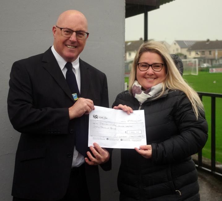 Alan Roach jnr hands over a £1,000 cheque to Withybush General Hospital nurse Leanne 